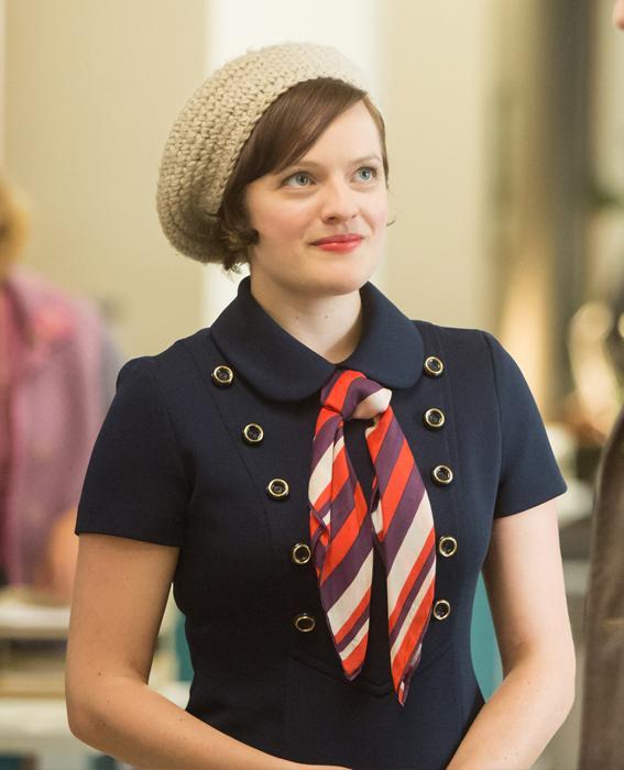 إليزابيث Moss as Peggy Olson in Mad Men wearing navy dress and hat